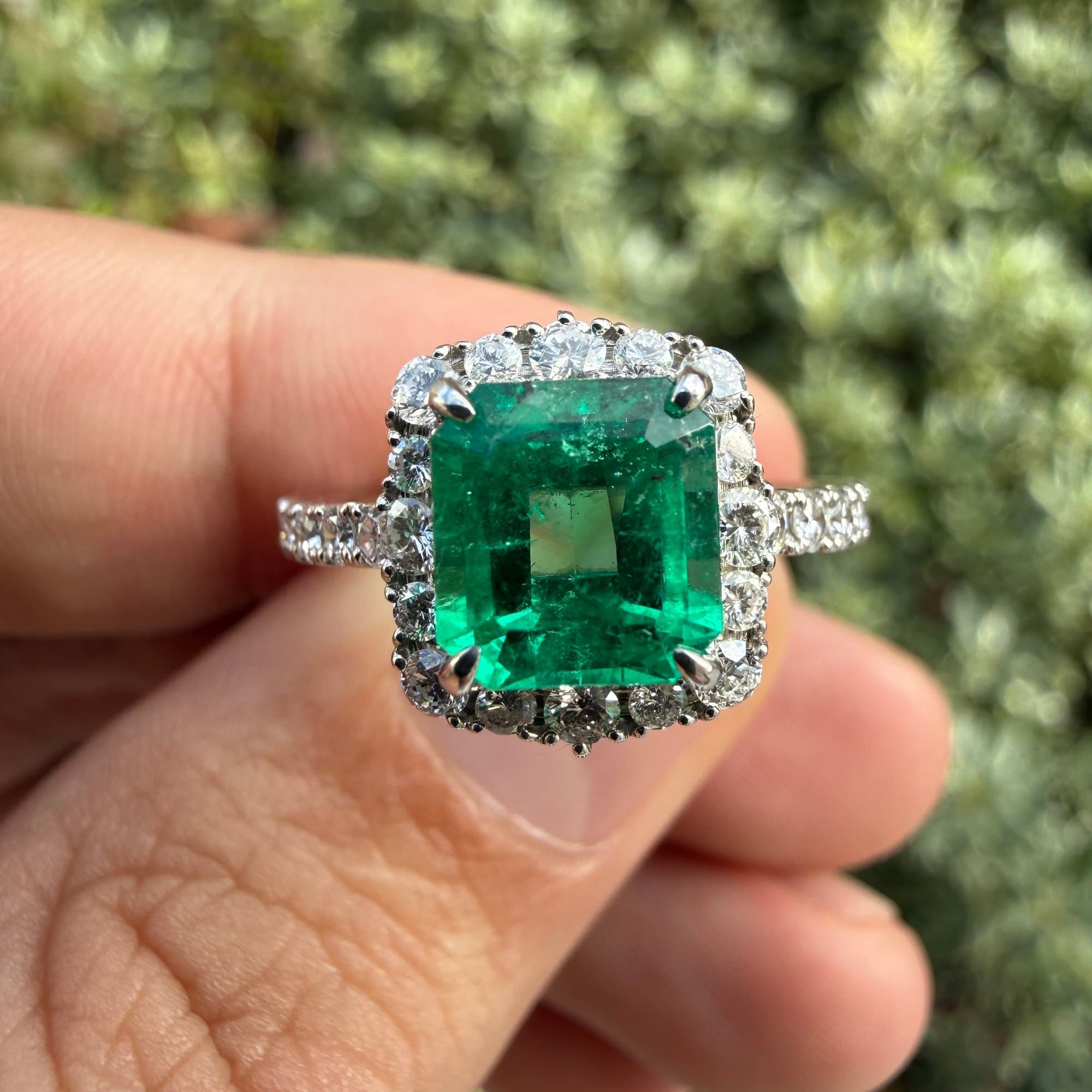 Stunning emerald ring with diamond halo - example of fine jewelry we purchase